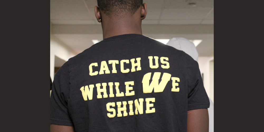 Image of student wearing shirt that reads 'Catch Up While We Shine'