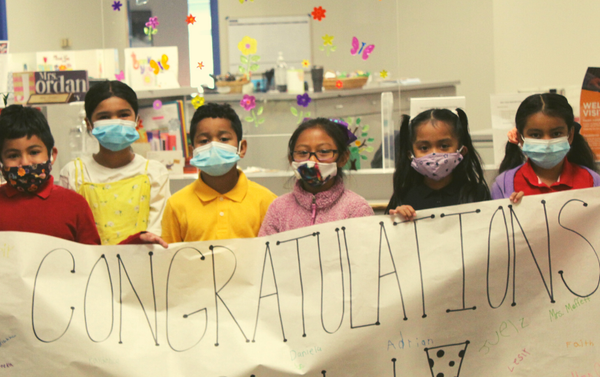 Sunny Heights Students hold handmade congratulations sign!