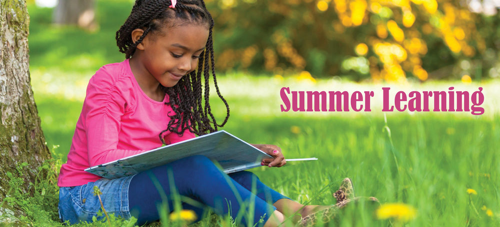 student reading under a tree