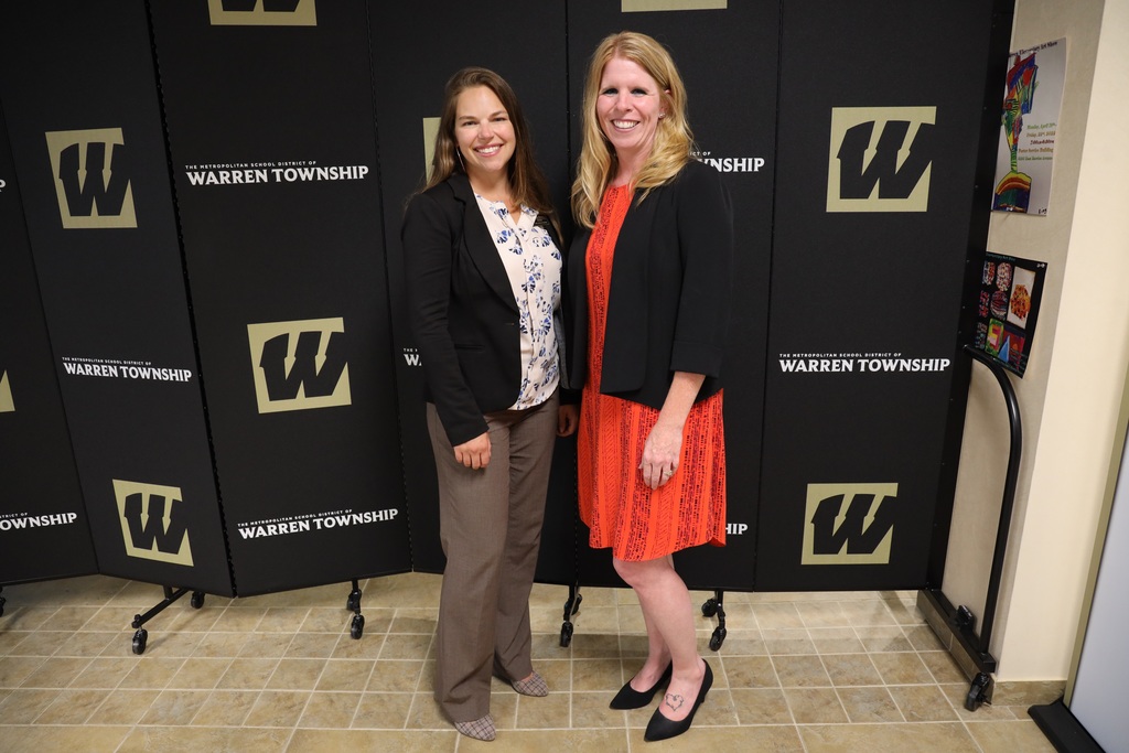 Director and Assistant Director at Board Meeting